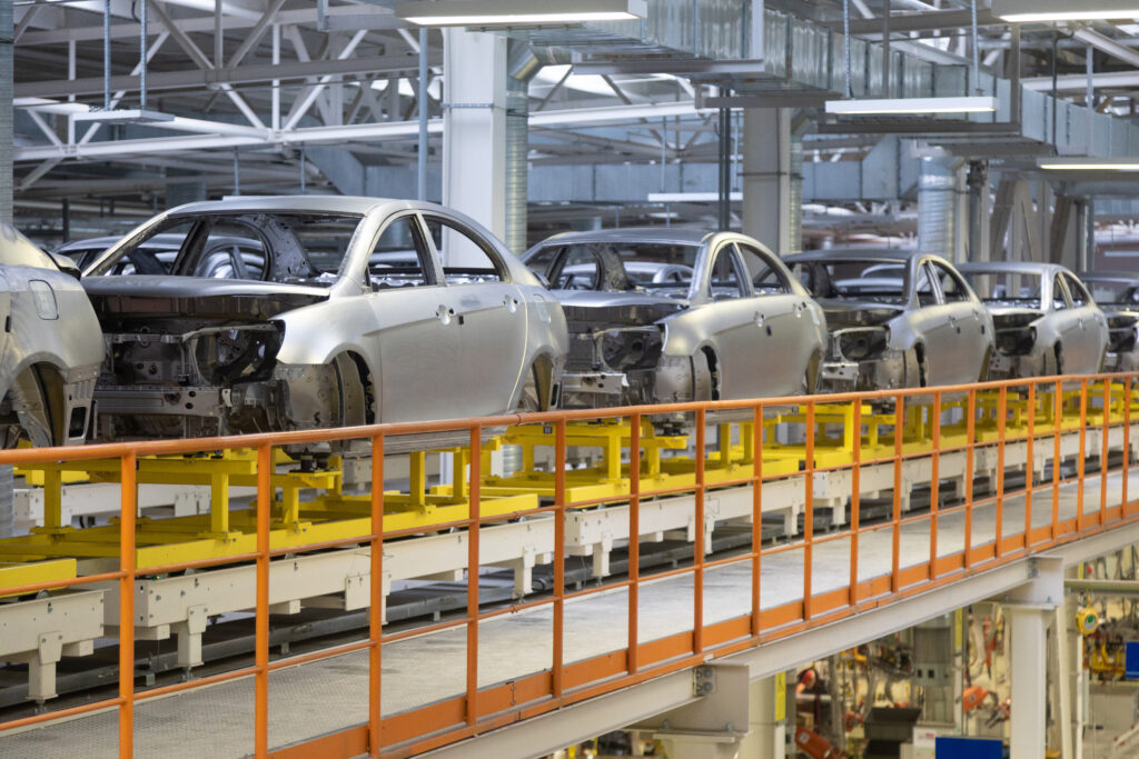 bodies of car on conveyor in a factory hall