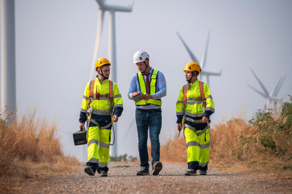 Engineer surveyor do an inspection in a wind turbine farm